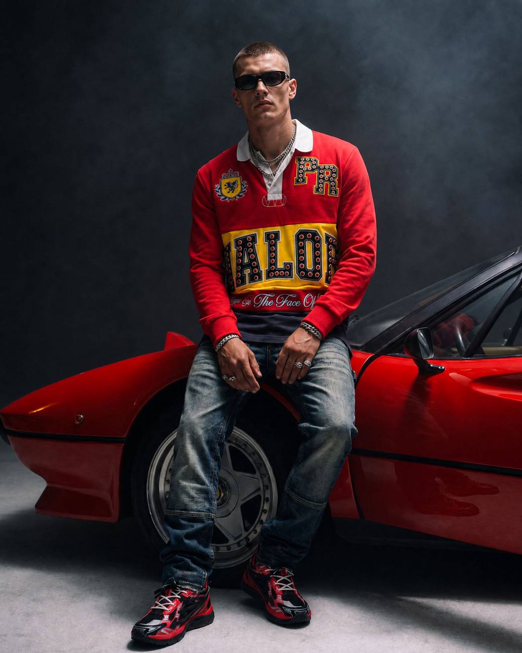 Model in a red PREME jacket on a red sports car